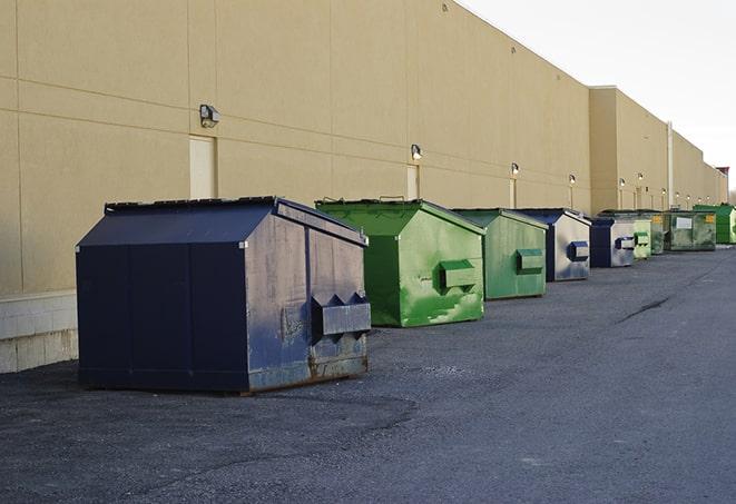 tilted front-load dumpsters being emptied by waste management workers in Belvedere